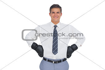 Businessman standing with black boxing gloves