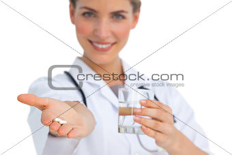 Drugs and water glass held by nurse