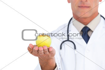 Focus shot on apple held by doctor