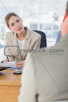 Smiling businesswoman looking at interviewee