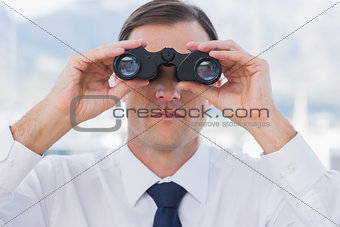 Close up of businessman using binoculars