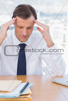 Anxious businessman holding his head