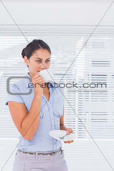 Attractive businesswoman drinking coffee