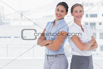 Businesswomen standing back to back