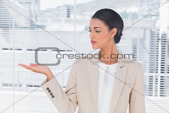 Attractive businesswoman opening her hand