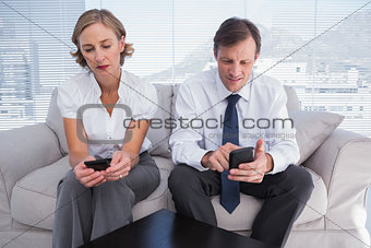 Business people typing on their mobile phones