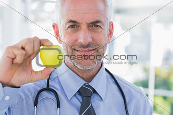 Doctor showing an apple