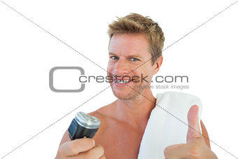 Cheerful man giving thumbs up while holding a razor