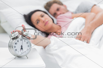 Woman turning off the alarm clock