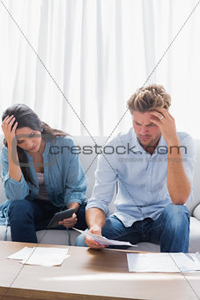 Upset couple doing their accounts