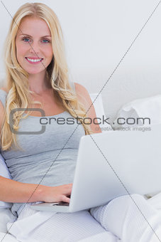 Blonde woman using her laptop