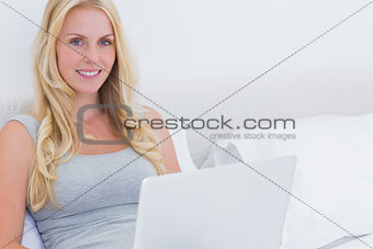Pretty blonde woman using her laptop