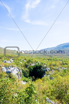 the entrance to a cave in the mountains of Dalmatia, Croatia 