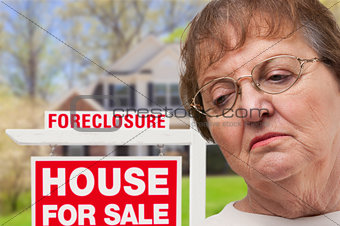 Depressed Senior Woman in Front of Foreclosure Real Estate Sign