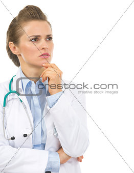 Portrait of thoughtful doctor woman looking on copy space