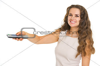 Smiling young woman switching channels with tv remote control