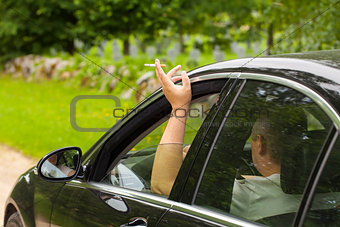 Driver with a cigarette  in car
