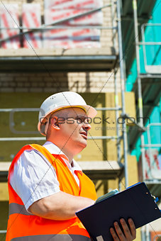 Construction Manager with folder at the scaffolding