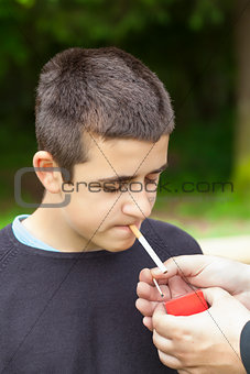 Boy with matches near the cigarette