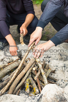 Father and son piling firewood for campfire
