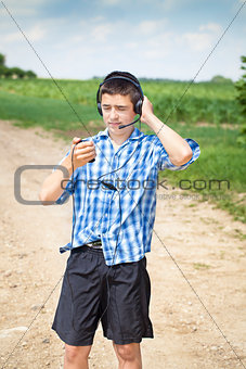 Boy with headphones and Mic on rural road