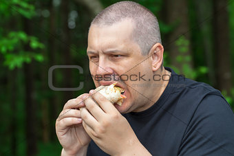 Man with burger and kebab in the hands
