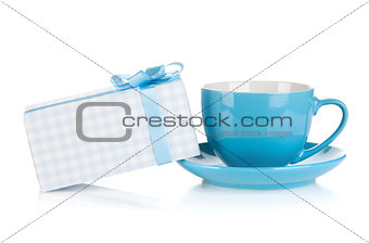 Blue coffee cup and gift box with bow