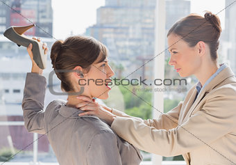 Businesswoman defending herself from her co worker strangling her