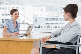 Businesswoman interviewing disabled candidate