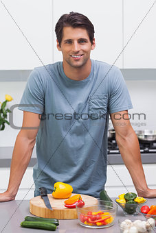 Attractive man standing in his kitchen