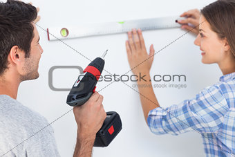 Woman and her husband measuring together