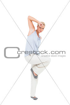 Blonde woman gesturing and looking at camera