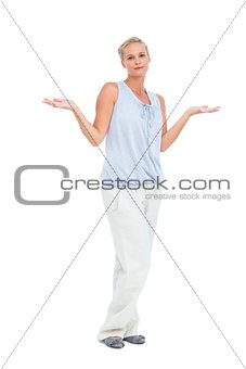 Blonde woman with arms raised in question looking at camera