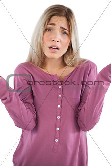 Confused young woman looking at camera