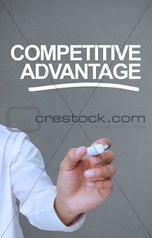 Businessman writing competitive advantage with a marker