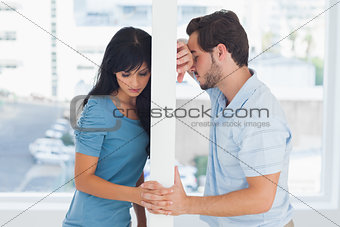 Divided couple are separated by white wall