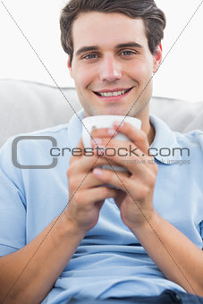Portrait of a man holding a cup of coffee