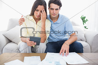 Anxious couple doing their accounts