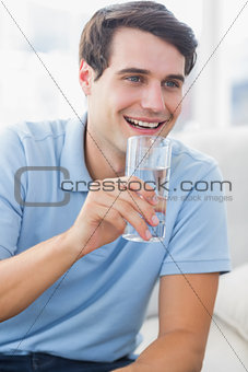 Cheerful man holding a glass of water