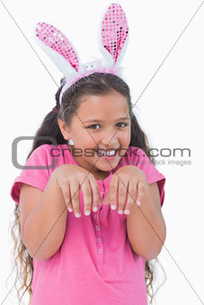 Little girl does an imitation of rabbit