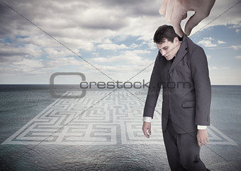 Giant hand dropping off a businessman