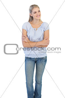 Smiling blonde woman crossing her arms