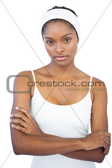Woman with headband crossing her arms