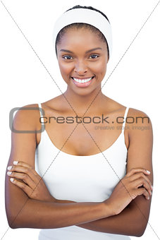 Smiling woman with headband crossing her arms