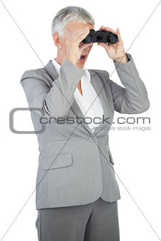 Businesswoman looking at something through binoculars