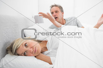 Woman refusing to listen to partner during a fight in bed