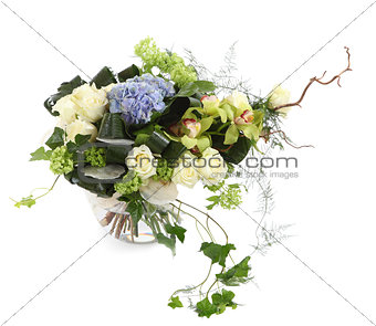 Floral arrangement of white roses, ivy and orchids, isolated ima