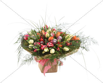 A large bouquet of color tulips in a square vase. Square floral
