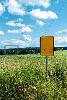 signpost in field with blue sky 