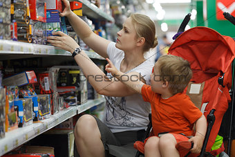 Mother and son shopping for toys